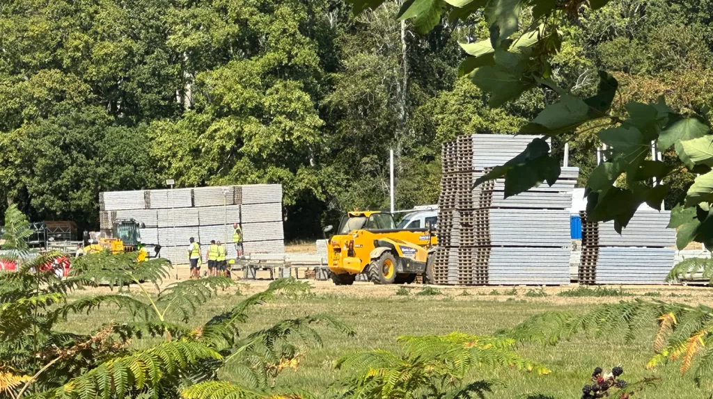 Heavy machinery and construction workers at Scientology's Saint Hill compound